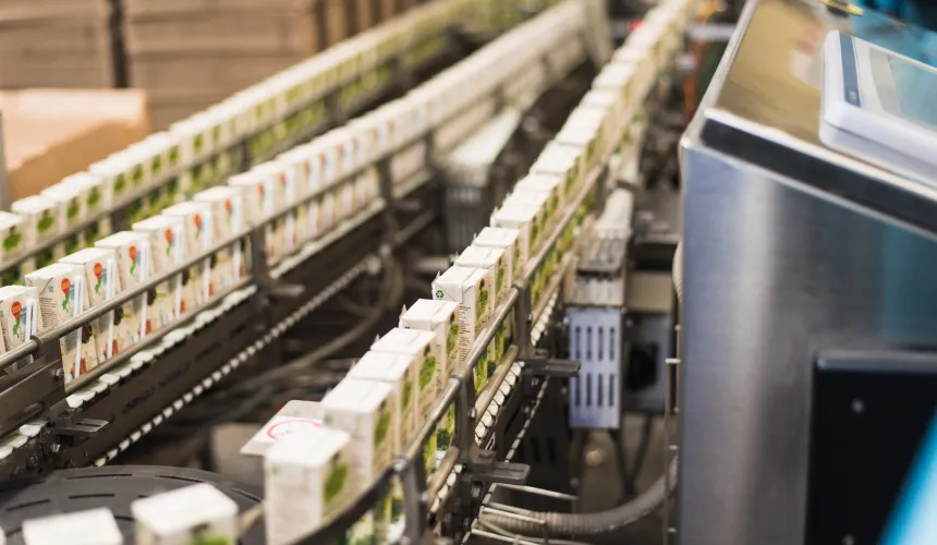 a food assembly line full of packaged juice